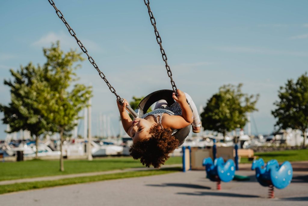 child enjoying a swing - new experiences - Treehouse Early Learning Manly Qld
